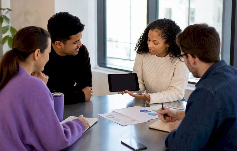 Group discussing shared expenses with app